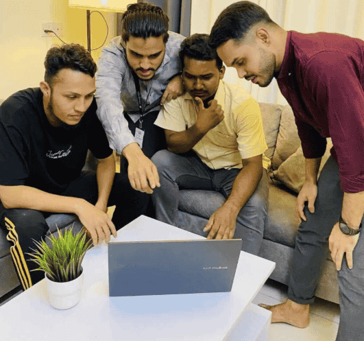 a group of of people discussing in an office